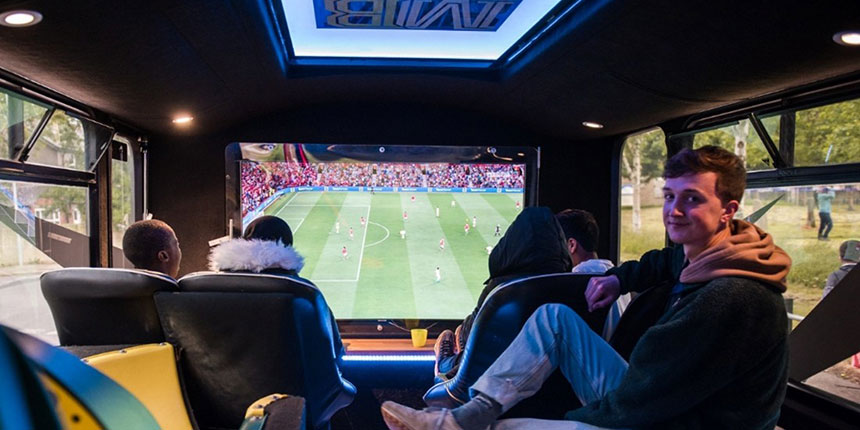 Young people gaming on big screen
